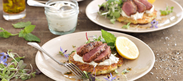 Lamb Medallions Served on Corn and Feta Fritters Topped with Fennel Tzatziki