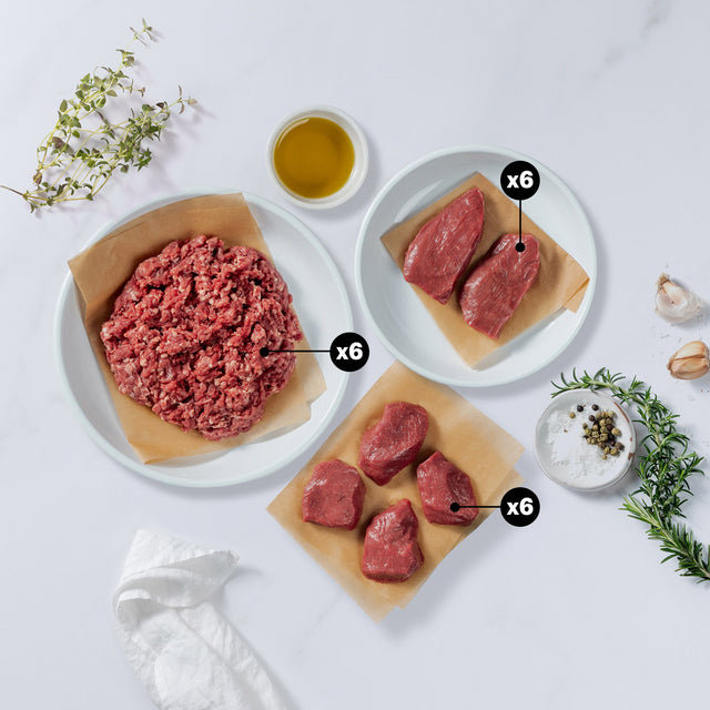 Silver Fern Farms lamb medallions, lamb steaks and ground lamb with x6 blurb each, placed with herbs, olive oil, garlic, salt and pepper at the side