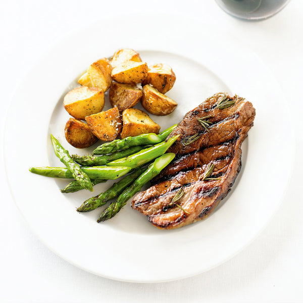 Sake Marinated New York Strip Steak serve with asparagus and potatoes