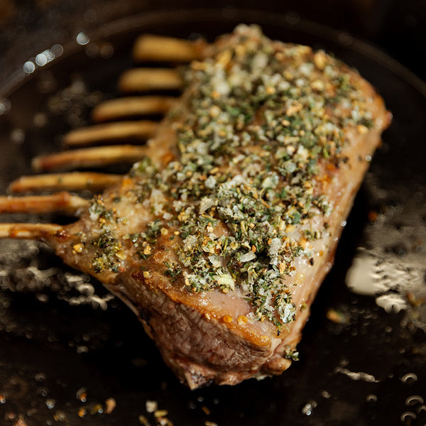 Grilled rack of lamb with herbs on a grill